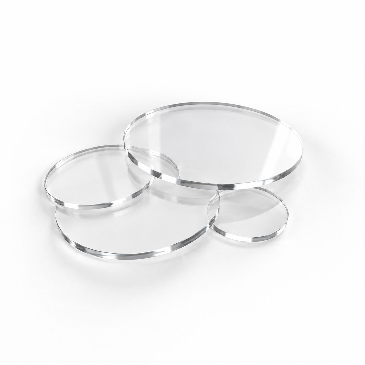 Clear acrylic discs in assorted sizes on a white background