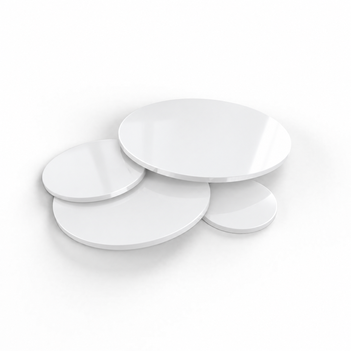 White acrylic discs in assorted sizes on a white background